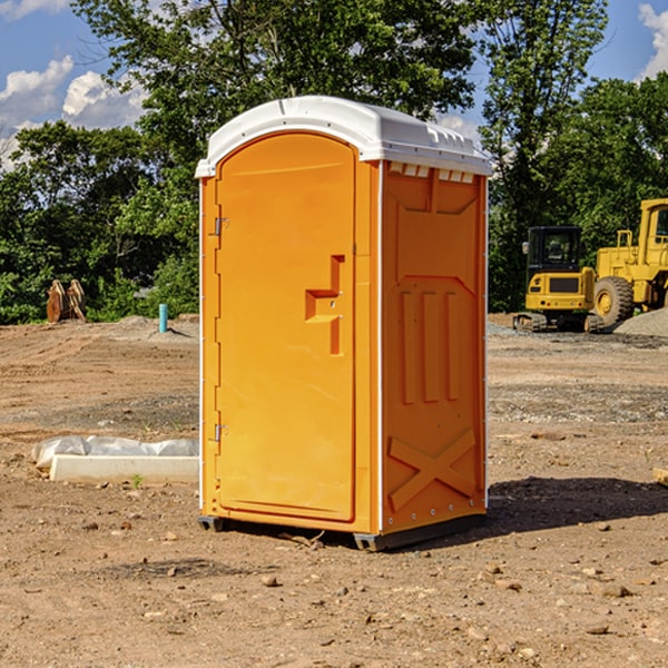 what is the cost difference between standard and deluxe portable toilet rentals in Comins
